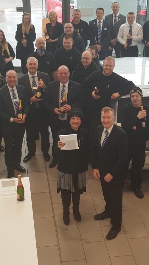 Jacqui Kaye Corkills VW brand manager and MD Adrian Kermode with dealership staff