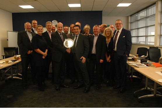 Ken Moore, regional aftersales manager Seat UK receives a trophy from Keith Kingham with manufacturer staff