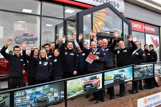 Robin Luscombe and staff at Luscombe Motors celebrate  their AM Best UK Dealerships to Work For award
