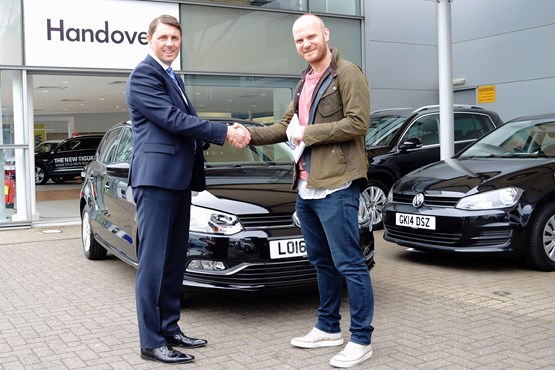 Coldplay drummer Will Champion collecting his Polo from Paul Tanner at Alan Day Volkswagen